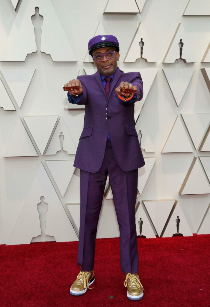 You can't really expect less from Spike Lee. I am jealous at how he wears this purple suit with golden sneakers.